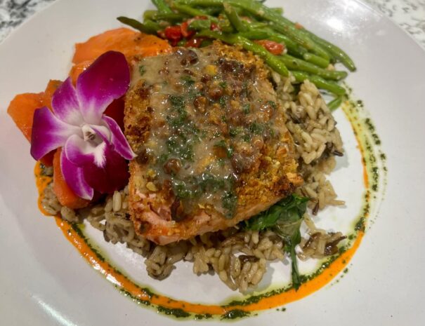 Crusted salmon with rice, green beans, and sauce.