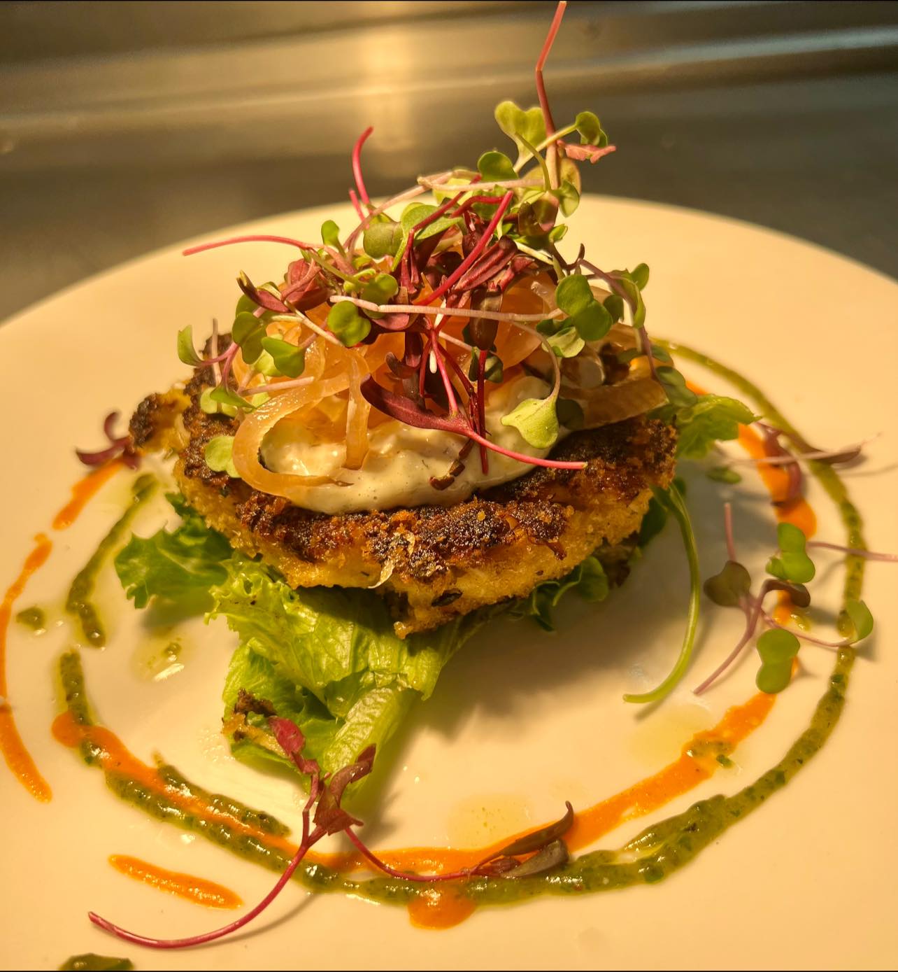 Hooville Crab Cake Topped with mixed greens, remoulade and pickled onions